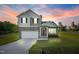 Charming two-story home with stone accents, a covered porch, an attached garage, and a well-manicured lawn at 482 Olivia Crossing Ct, Four Oaks, NC 27524