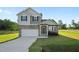 Charming two-story home with stone accents, a covered porch, an attached garage, and a well-manicured lawn at 482 Olivia Crossing Ct, Four Oaks, NC 27524