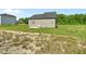 View of the home's rear exterior with a grassy backyard at 482 Olivia Crossing Ct, Four Oaks, NC 27524