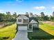 Charming two-story home with a gray exterior, landscaped yard, and driveway at 482 Olivia Crossing Ct, Four Oaks, NC 27524