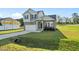 Charming two-story home with stone accents, a covered porch, an attached garage, and a well-manicured lawn at 482 Olivia Crossing Ct, Four Oaks, NC 27524