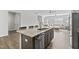 A kitchen island featuring granite countertops, stainless steel dishwasher, and bar seating, blending seamlessly into the living area at 482 Olivia Crossing Ct, Four Oaks, NC 27524