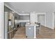 Modern kitchen boasts stainless steel appliances, gray cabinetry, and a granite countertop island with bar seating at 482 Olivia Crossing Ct, Four Oaks, NC 27524
