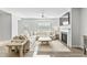 The open-concept living room includes a fireplace, a large sectional sofa, and lots of natural light from the window at 482 Olivia Crossing Ct, Four Oaks, NC 27524