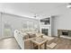 Bright living room with a plush sectional sofa, a fireplace with mounted TV, and an inviting, airy feel at 482 Olivia Crossing Ct, Four Oaks, NC 27524