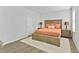 A serene bedroom features a wooden bed frame, soft lighting, and neutral tones, creating a cozy and relaxing atmosphere at 482 Olivia Crossing Ct, Four Oaks, NC 27524