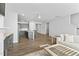 Open concept living space with kitchen island, large seating arrangement and seamlessly connected living areas at 482 Olivia Crossing Ct, Four Oaks, NC 27524