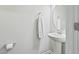 Bright powder room with pedestal sink, round mirror, and neutral paint at 482 Olivia Crossing Ct, Four Oaks, NC 27524