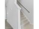 Carpeted staircase with white banister and gray handrail at 482 Olivia Crossing Ct, Four Oaks, NC 27524
