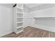 Walk-in closet with built-in shelving and wood look flooring at 482 Olivia Crossing Ct, Four Oaks, NC 27524