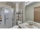 Bathroom featuring a shower with glass door, toilet, and sink with a large mirror at 4907 Hollenden Dr # 106, Raleigh, NC 27616