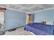 Spacious bedroom with blue walls, light floors, and access to an adjacent room at 4907 Hollenden Dr # 106, Raleigh, NC 27616