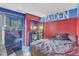 This bedroom features a unique design with bold colors, a cozy bed, and a dresser at 4907 Hollenden Dr # 106, Raleigh, NC 27616