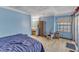 This light-filled bedroom has ample space, natural light, and essential furnishings for comfortable living at 4907 Hollenden Dr # 106, Raleigh, NC 27616