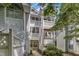 Exterior angle shot of a multi-story apartment building with latticed balconies and well maintained landscaping at 4907 Hollenden Dr # 106, Raleigh, NC 27616