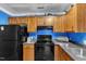 A cozy kitchen features wood cabinets, modern appliances, and a practical layout for cooking and storage at 4907 Hollenden Dr # 106, Raleigh, NC 27616