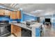 Kitchen with black appliances, wood cabinets, countertop with sink, and open view to living room at 4907 Hollenden Dr # 106, Raleigh, NC 27616