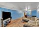 Bright living room showcasing wood floors, sectional sofa, and TV at 4907 Hollenden Dr # 106, Raleigh, NC 27616