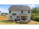 A backyard featuring a grill on a concrete patio, and a covered porch with outdoor seating at 5 Cinnamon Teal Way, Youngsville, NC 27596