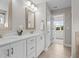 Bathroom vanity with double sinks, white cabinets, and modern fixtures at 5 Cinnamon Teal Way, Youngsville, NC 27596