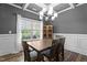 Formal dining room with elegant lighting, wainscoting, and an expansive window at 5 Cinnamon Teal Way, Youngsville, NC 27596