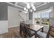 Dining area featuring an elegant light fixture and staircase in view at 5 Cinnamon Teal Way, Youngsville, NC 27596