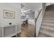 Entryway features wood flooring, a staircase, and a view of the dining room with a decorative coffered ceiling at 5 Cinnamon Teal Way, Youngsville, NC 27596