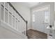 Bright entryway features wood flooring, stairs with white banisters, and front door with sidelights at 5 Cinnamon Teal Way, Youngsville, NC 27596