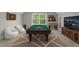 Game room with pool table, foosball table, and comfortable seating for entertainment at 5 Cinnamon Teal Way, Youngsville, NC 27596
