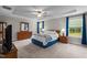 Spacious main bedroom featuring a tray ceiling, ceiling fan, and a window offering plenty of natural light at 5 Cinnamon Teal Way, Youngsville, NC 27596