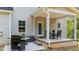 Covered patio with seating area and grill, perfect for outdoor entertaining at 5 Cinnamon Teal Way, Youngsville, NC 27596