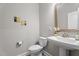 Stylish powder room with pedestal sink and decorative wall art at 5 Cinnamon Teal Way, Youngsville, NC 27596