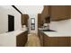 Modern kitchen features white countertops, wood cabinets, and stainless steel appliances at 512 Gordon Street # 304, Durham, NC 27701