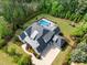 An aerial view of a home boasting a private pool, play area, meticulous landscaping, and surrounding trees at 5125 Avalaire Oaks Dr, Raleigh, NC 27614