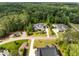 Wide aerial view of the neighborhood with beautiful homes, manicured lawns, and a lush, green surrounding landscape at 5125 Avalaire Oaks Dr, Raleigh, NC 27614