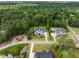 Aerial view of a home with backyard pool nestled among lush greenery in a serene, wooded neighborhood at 5125 Avalaire Oaks Dr, Raleigh, NC 27614