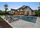 Beautiful backyard pool features lounge chairs, umbrellas and lighting, perfect for relaxation and entertaining at 5125 Avalaire Oaks Dr, Raleigh, NC 27614