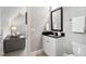 Neutral-toned half bath with a black countertop and a view of the living room at 5125 Avalaire Oaks Dr, Raleigh, NC 27614