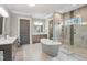 Luxurious bathroom with freestanding tub, glass shower, and dual vanities at 5125 Avalaire Oaks Dr, Raleigh, NC 27614