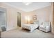 Cozy bedroom offering neutral color palette, soft natural light, and adjacent bathroom at 5125 Avalaire Oaks Dr, Raleigh, NC 27614