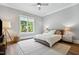Bright bedroom with hardwood floors, neutral walls, a plush rug, and a backyard view at 5125 Avalaire Oaks Dr, Raleigh, NC 27614
