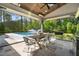 Covered patio with outdoor kitchen, dining and view of the backyard and pool at 5125 Avalaire Oaks Dr, Raleigh, NC 27614
