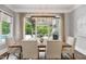 Dining room with modern chandelier, table with seating and view to the outdoor kitchen and pool at 5125 Avalaire Oaks Dr, Raleigh, NC 27614