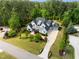 Aerial shot of a stunning home with a well-manicured lawn, lush landscaping, and a long, winding driveway at 5125 Avalaire Oaks Dr, Raleigh, NC 27614
