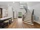 Grand foyer showcasing hardwood floors, staircase, and striking double entry doors at 5125 Avalaire Oaks Dr, Raleigh, NC 27614