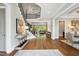 Elegant foyer with hardwood floors, staircase, and a view into the open-concept living space at 5125 Avalaire Oaks Dr, Raleigh, NC 27614