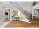 Grand foyer featuring hardwood floors, a staircase, and stylish console table with art at 5125 Avalaire Oaks Dr, Raleigh, NC 27614