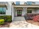 The home's entrance has double doors, stone steps, and symmetrical landscaping for a welcoming curb appeal at 5125 Avalaire Oaks Dr, Raleigh, NC 27614