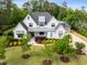 Stunning two-story home with professional landscaping, gray roof, and a welcoming covered front porch at 5125 Avalaire Oaks Dr, Raleigh, NC 27614