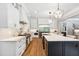 Spacious kitchen featuring an island with bar seating, stainless appliances, and custom cabinetry at 5125 Avalaire Oaks Dr, Raleigh, NC 27614